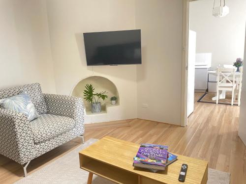 a living room with a couch and a table at Rosa's Place Close to South Beach in South Fremantle
