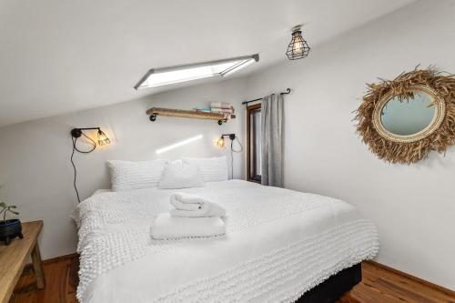 a bedroom with a white bed and a mirror at Fabrik Loft Central New York Stylequiet in Fremantle
