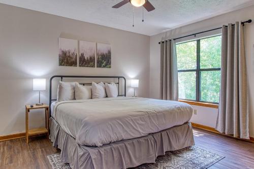 a bedroom with a large bed and a window at Pool-Pinecrest Townhomes-Full Building-14bed17bath in Pigeon Forge