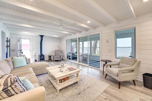 a living room with a couch and a table and chairs at Sunny Mears Vacation Rental with Private Beach! in Mears