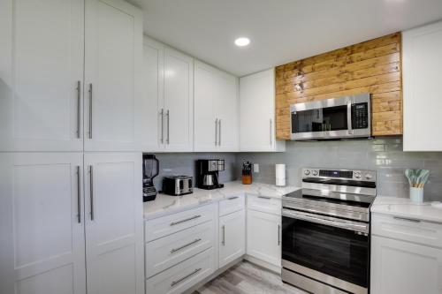 a white kitchen with white cabinets and appliances at Private Pool and Guest House Spacious Kemp Home! in Kemp
