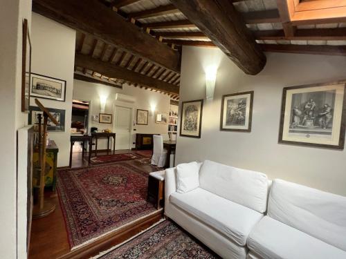 a living room with a white couch and a table at a casa di paola in Ravenna