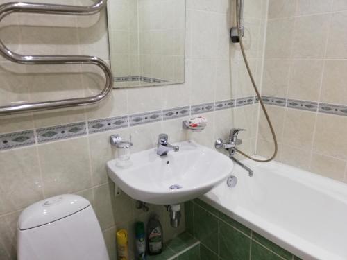 a bathroom with a sink and a toilet and a tub at 15 minutes from the Beach and city Center 7 minutes from the airport in Riga