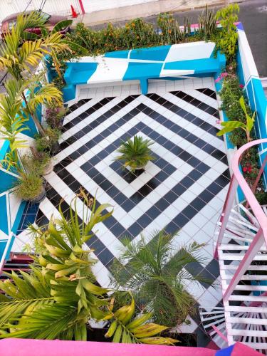 an overhead view of a patio with plants and a bench at Posada Bugambilia in Mexico City