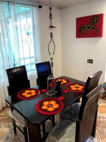 a black dining room table with pumpkins on it at Hermosa Cabaña Campestre Puente Boyacá in Ventaquemada