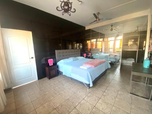 a bedroom with a large bed and a mirror at Ica Adventures II in Ica
