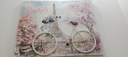 a painting of a bike with the eiffel tower at Dulce hogar baño compartido in Chía