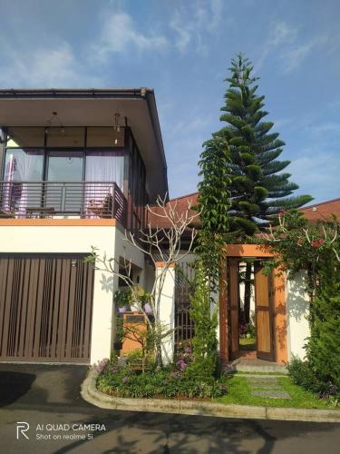 a house with a pine tree in front of it at Vimala Hills FARLA Villa - 3BR in Gadok 1