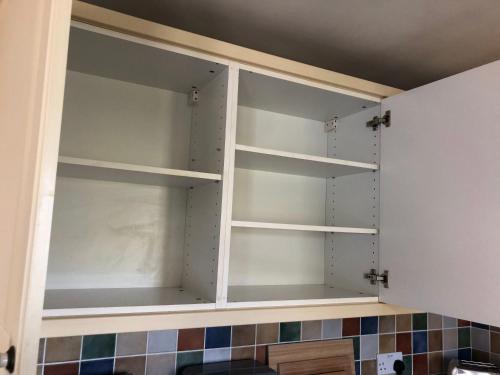 a room with empty shelves in a kitchen at The Burnham House in Bath