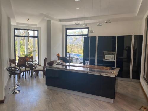 a kitchen with a counter and a dining room at San Fernando de la Cruz in Riobamba