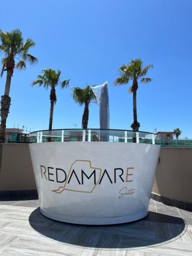a sign for the redzone with palm trees in the background at REDAMARE SUITE in Lago Patria