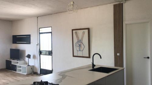 a kitchen with a counter and a sink in a room at Los Pinos in Alginet