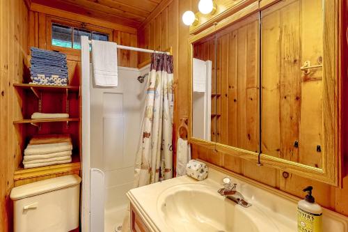 a bathroom with a sink and a white refrigerator at The Cabin on the Lake in Worley