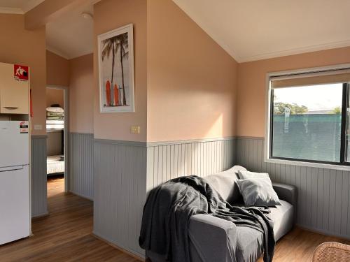 a living room with a couch and a window at South Coast Retreat in Greenwell Point