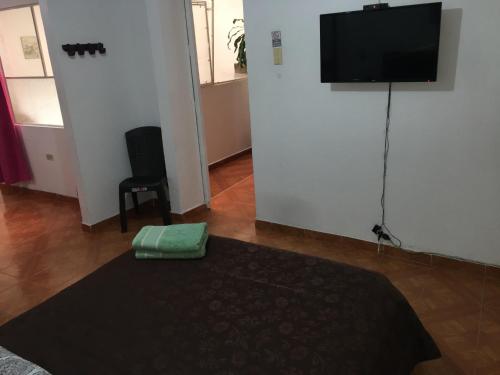 a room with a flat screen tv on a wall at Dorado Airport rooms & apartments in Bogotá