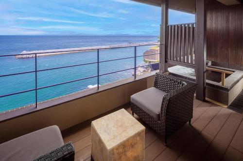 a balcony with a view of the ocean at Amahara in Sumoto
