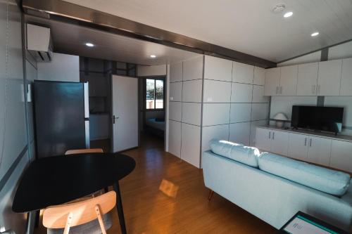 a kitchen with a table and a blue couch at Norwesta Lifestyle Park in Carnarvon