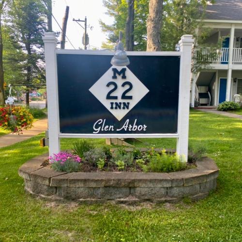 a sign in front of a house with a yard at M22 Inn Glen Arbor in Glen Arbor