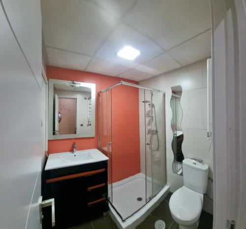a bathroom with a shower and a toilet and a sink at Apartamentos Salamanca in Málaga
