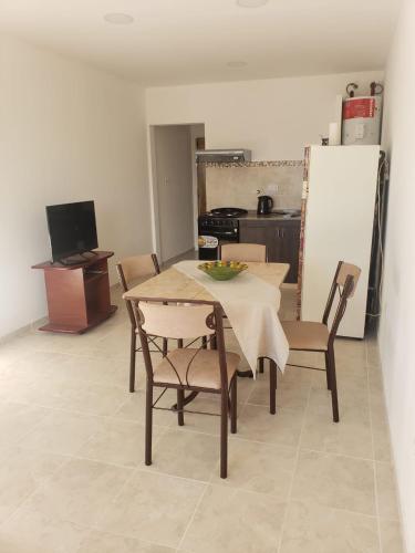 a kitchen with a table and chairs and a refrigerator at Luminoso dpto con wifi in San Luis