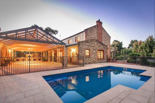 a house with a swimming pool in front of it at Hahndorf Luxury Retreat 5 bedrooms for 12 guests in Hahndorf