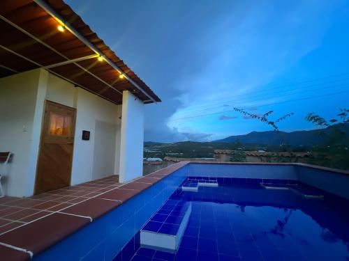 a villa with a swimming pool at night at Glamping Sierra de Luna in Villa de Leyva