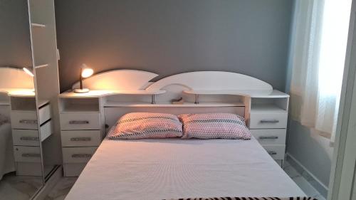 a bedroom with a bed with two pillows on it at Cantinho FW in Ubatuba