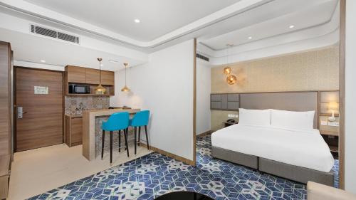 a hotel room with a bed and a kitchen at Holiday Inn Gurugram Sector 90 by IHG in Gurgaon