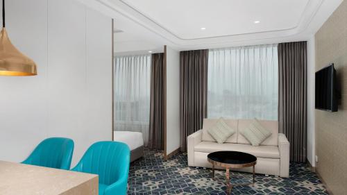 a hotel room with a couch and a table at Holiday Inn Gurugram Sector 90 by IHG in Gurgaon