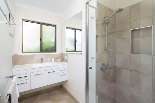 a bathroom with a shower and a sink at 64 San Remo Parade San Remo in San Remo