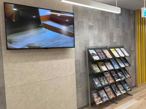 a flat screen tv on a wall in a store at Smile Hotel Nagano in Nagano