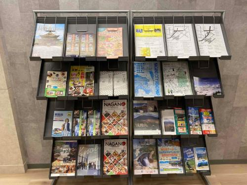 a book shelf filled with lots of books at Smile Hotel Nagano in Nagano