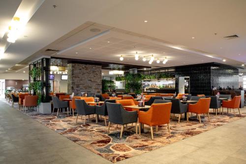 a dining area with tables and chairs in a restaurant at Young Federation Motor Inn and Services Club in Young