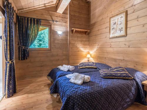 Un dormitorio con una cama azul con toallas. en Appartement Saint-Martin-de-Belleville, 4 pièces, 8 personnes - FR-1-461-21, en Saint-Martin-de-Belleville