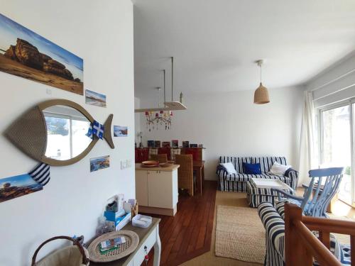 un salon avec deux chaises et un miroir dans l'établissement Duplex à 50m de la plage avec parking et 2 chambres - FR-1-368-391, à Trégastel