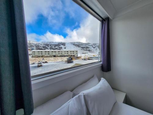 a window in a room with a view of a street at Pipers Lodge in Perisher Valley