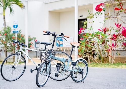 two bikes parked next to each other on a street at Hotel California Miyakojima Resort in Miyako Island