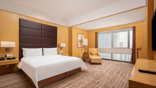 a hotel room with a bed and a desk and a window at Holiday Inn Shijiazhuang Central by IHG in Shijiazhuang