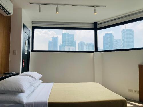 a bedroom with a bed and a large window at Gomez House in Manila
