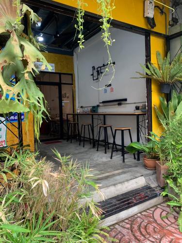 a projection screen in a room with plants at Enterspace Chinatown in Khlong San