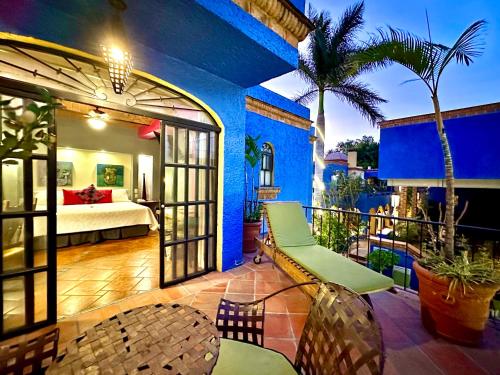 a hotel room with a bed and a balcony at La Villa del Ensueno Boutique Hotel in Guadalajara