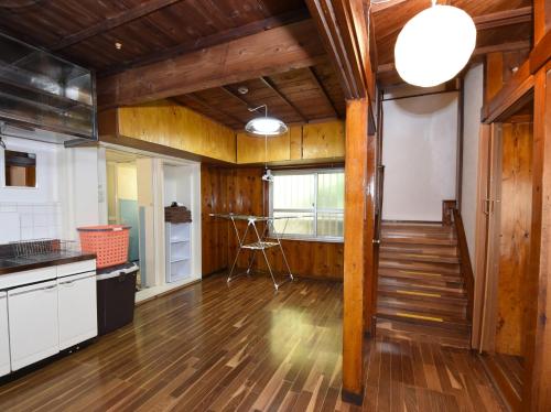 a kitchen with wooden walls and a wooden floor at Japanese Onlyの古民家-Villa Ukishima- in Naha