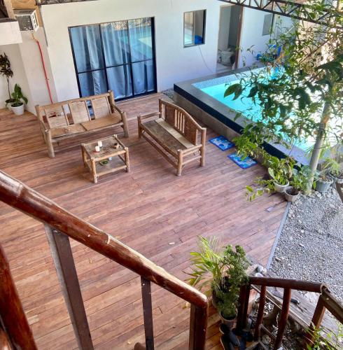 an indoor patio with a pool and wooden furniture at Babu Backpackers inn in Moalboal