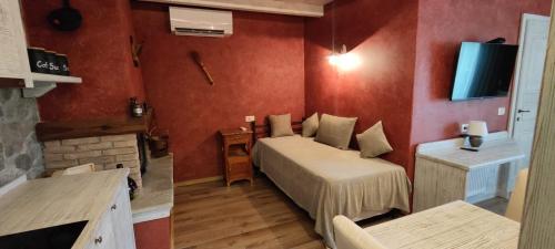 a bedroom with a bed and a tv on a wall at ČEBRON FAMILY ESTATE in Branik