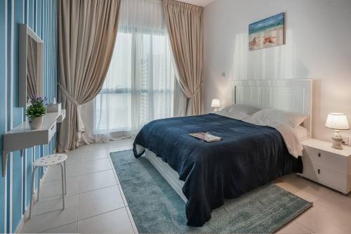 a bedroom with a bed and a large window at GREAT 3 Bedroom Apartment Beach Front (City View) in Abu Dhabi