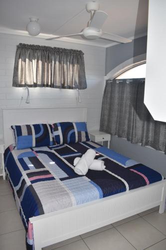 a bedroom with a bed with two stuffed animals on it at Crystal Waters 7 in Bargara