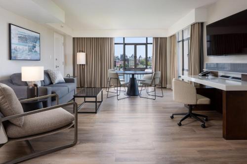 a living room with a couch and a table at Delta Hotels by Marriott Victoria Ocean Pointe Resort in Victoria