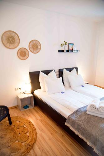 a bedroom with a large bed with white pillows at Gutshof zum Wurzgarten in Hainbach