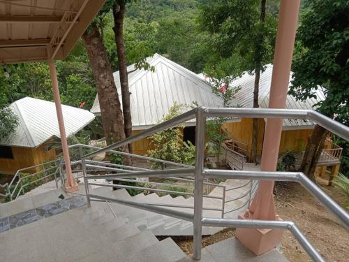 a staircase leading up to a house with a building at Woodland Inn in El Nido