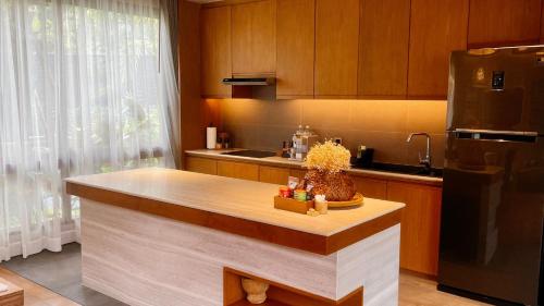 a kitchen with a counter and a refrigerator at Rarin Villas in Chiang Mai